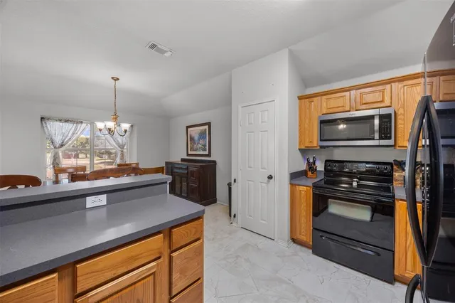 a kitchen with a sink and stainless steel appliances