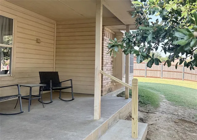 a view of a house with backyard and a sitting area
