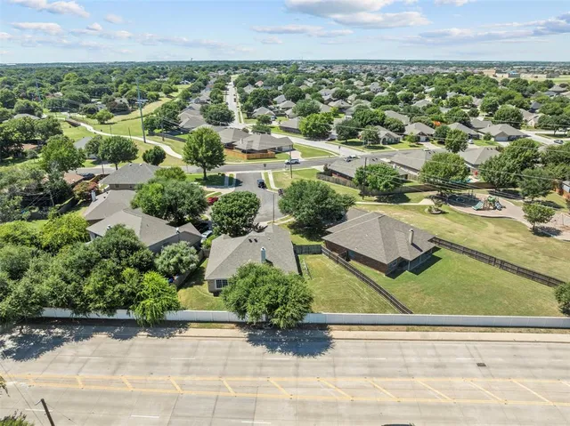 an aerial view of residential houses with outdoor space