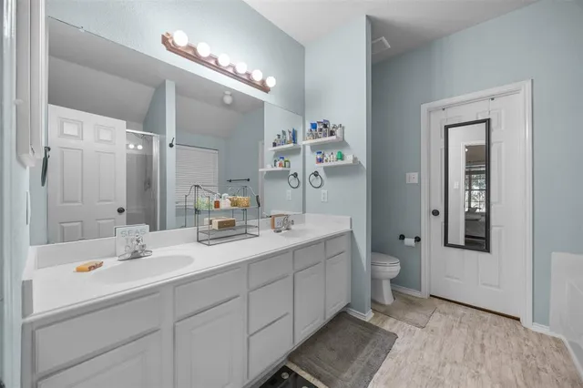 a bathroom with a sink double vanity and a mirror