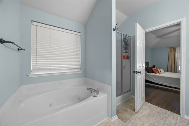 a bathroom with a bathtub and a shower