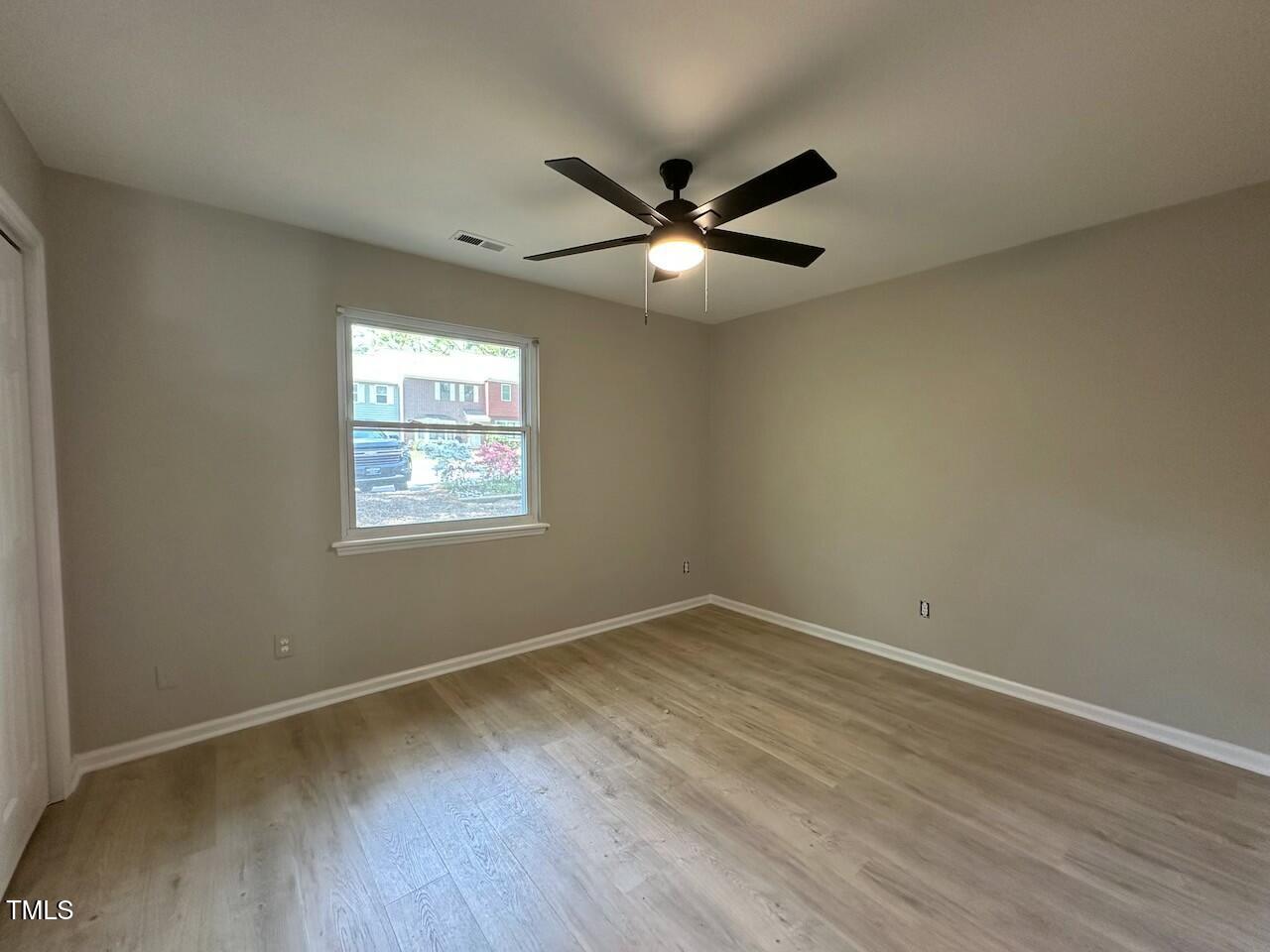 5400 Pine Top Circle Raleigh, NC 27612 - Photo 14 of 18 a view of an empty room with wooden floor and a window