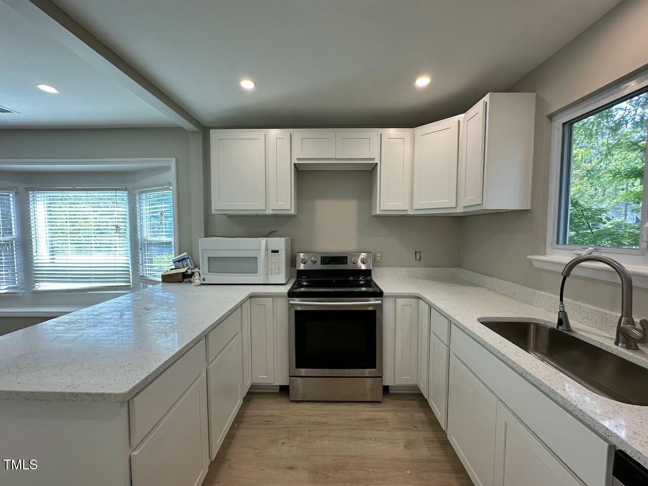 5400 Pine Top Circle Raleigh, NC 27612 - Photo 3 of 18 a kitchen with a sink stove and cabinets