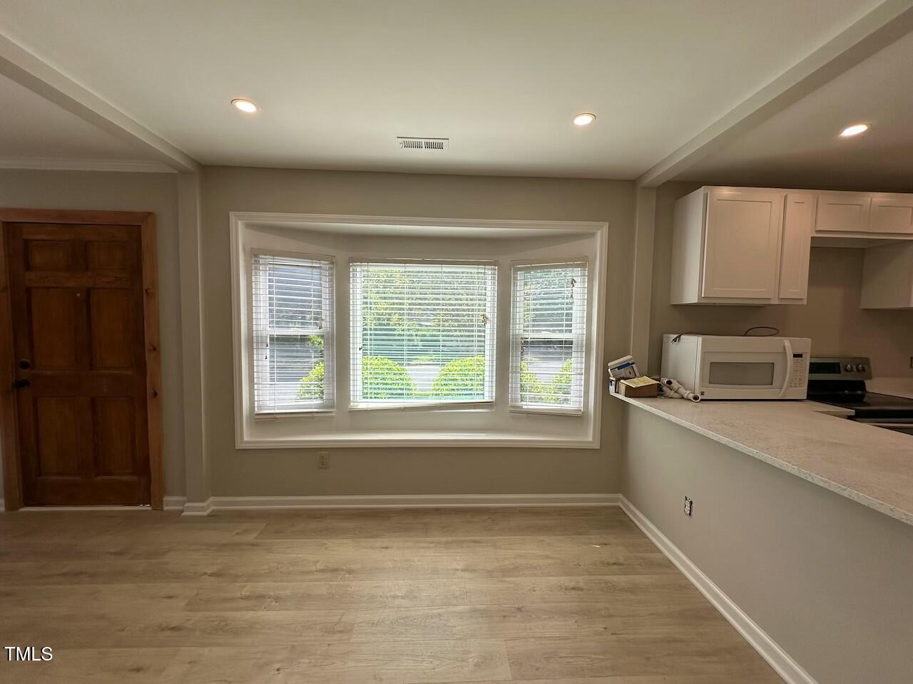 5400 Pine Top Circle Raleigh, NC 27612 - Photo 5 of 18 a kitchen with stainless steel appliances granite countertop a sink and cabinets with wooden floor