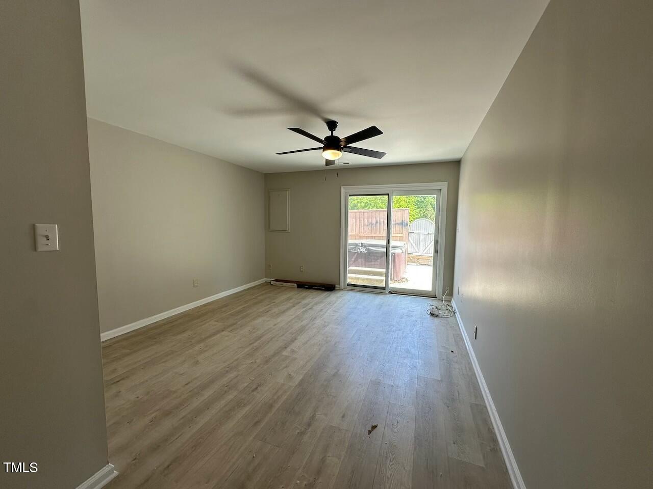 5400 Pine Top Circle Raleigh, NC 27612 - Photo 10 of 18 an empty room with wooden floor and windows