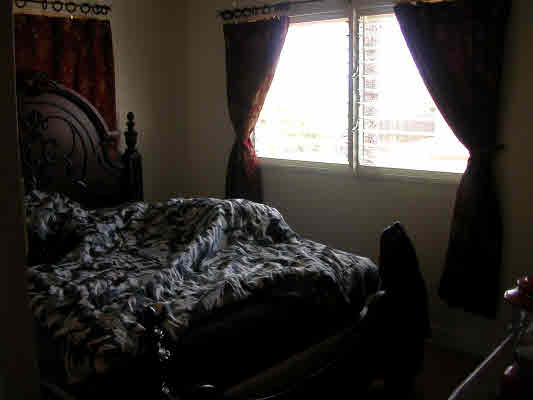 4896 Nunu Road Kapaa, HI 96746 - Photo 8 of 10 a bed sitting in a bedroom next to a window