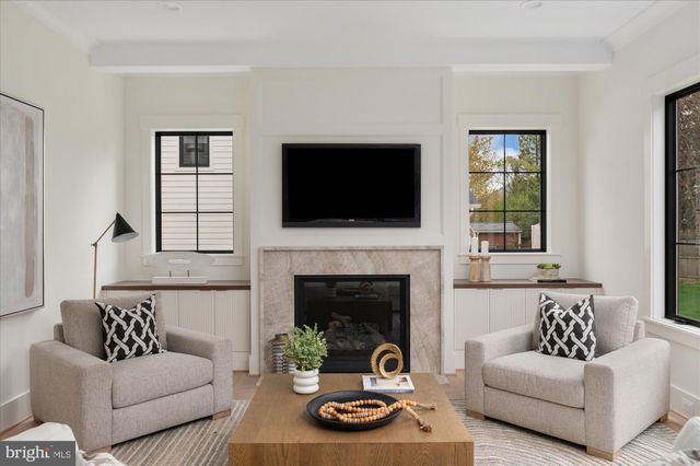 a view of a hallway with wooden floor and entryway