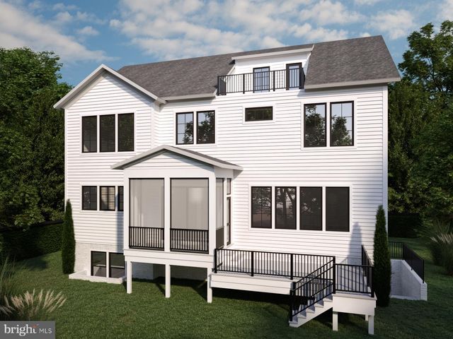 a white house with a large window and a yard in front of it