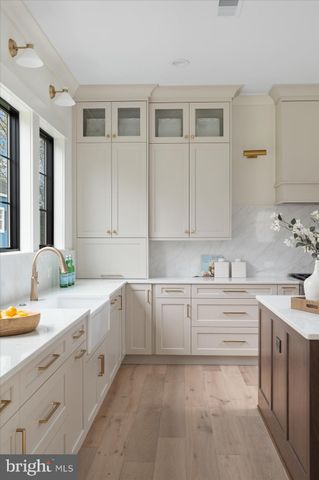 a living room with furniture large window and wooden floor
