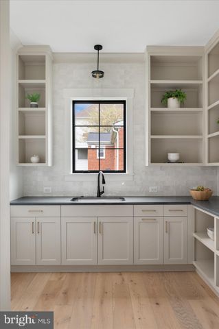 a kitchen with stainless steel appliances granite countertop a sink and a stove