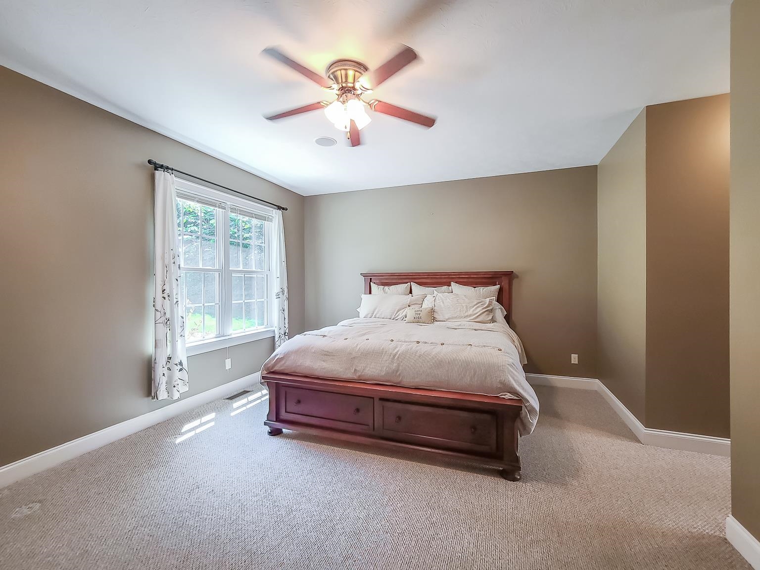 6089 Faughts Road Mount Crawford, VA 22841 - Photo 28 of 68 a spacious bedroom with a bed and a chandelier