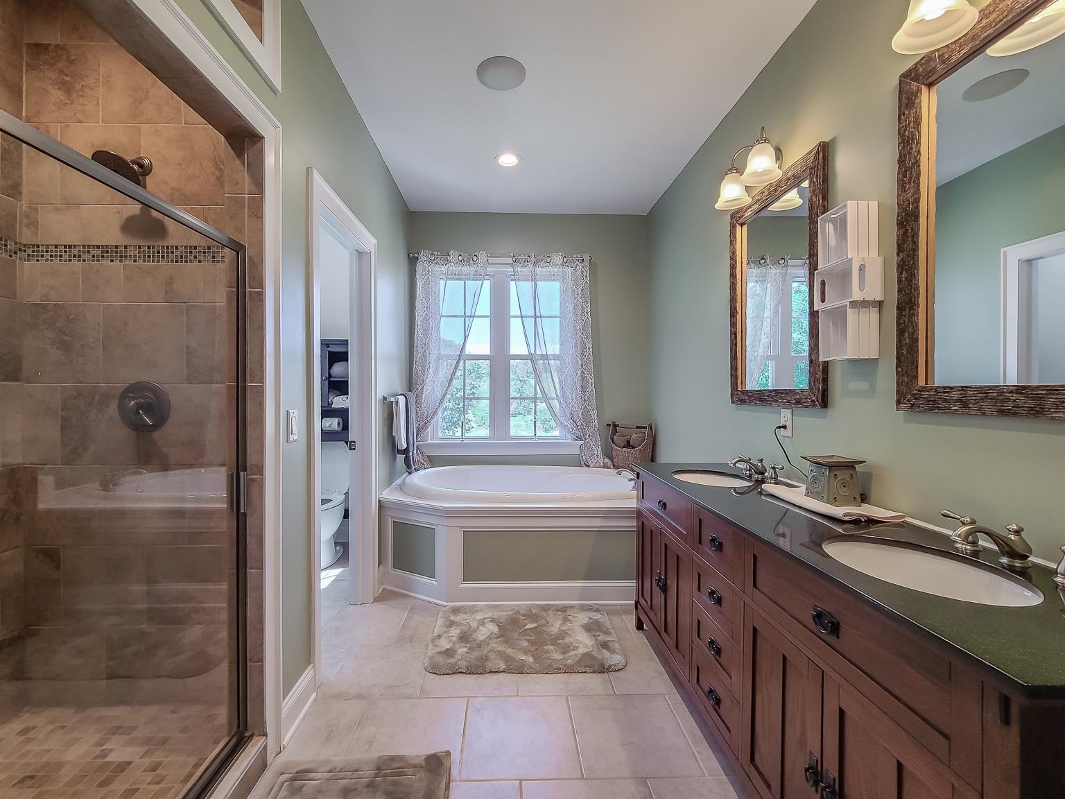 6089 Faughts Road Mount Crawford, VA 22841 - Photo 29 of 68 a bathroom with a tub sink and mirror
