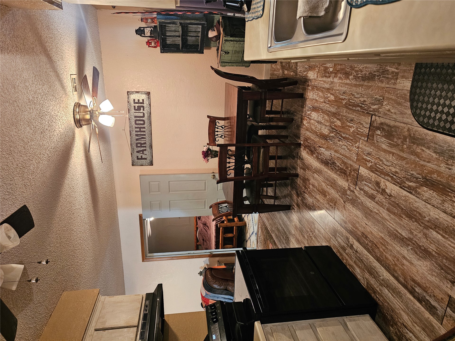 106441 South 4163rd Road Checotah, OK 74426 - Photo 5 of 17 vinyl flooring throughout, kitchen stainless steel sink, and built-in ceiling fan with integrated lighting