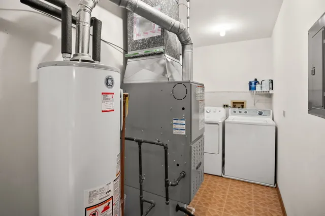 a view of storage and utility room with washer and dryer