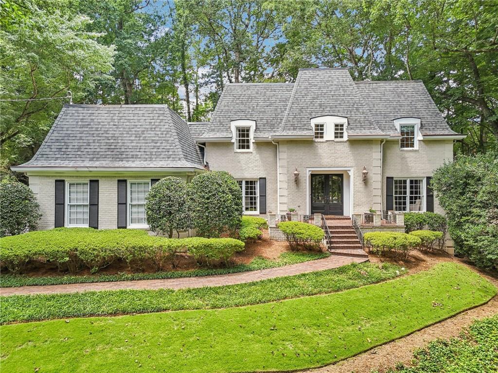 a front view of a house with a yard table and chairs