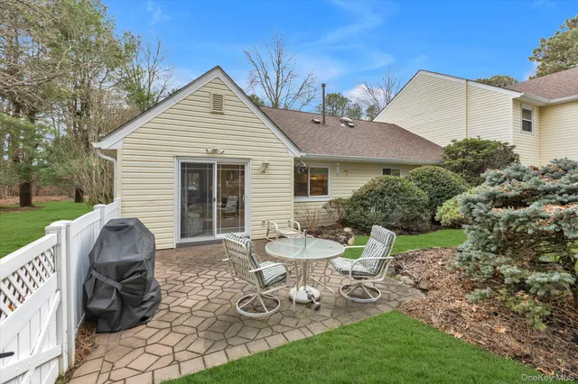 a view of a chairs and table in backyard of the house