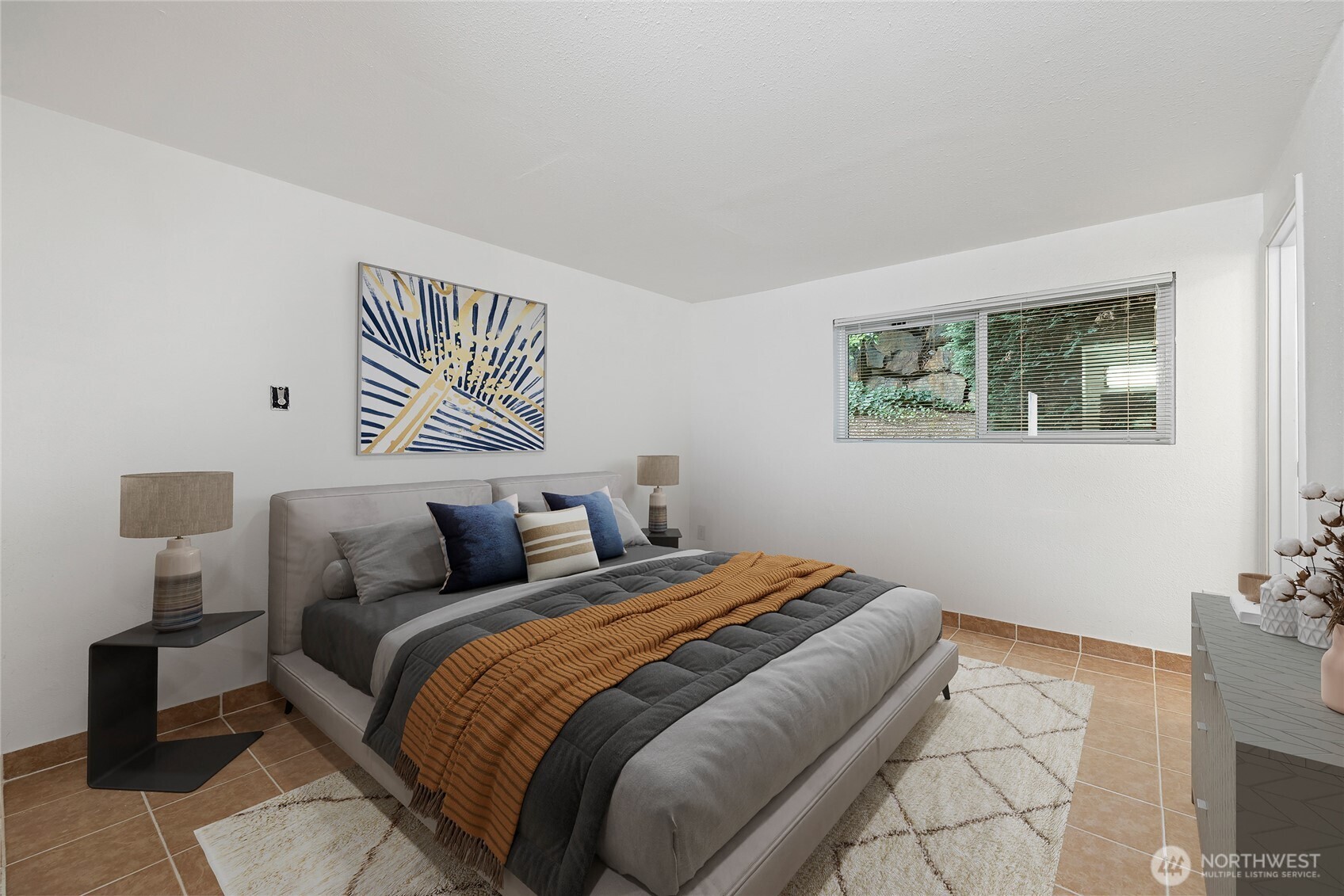 a bedroom with a bed and a painting on the wall