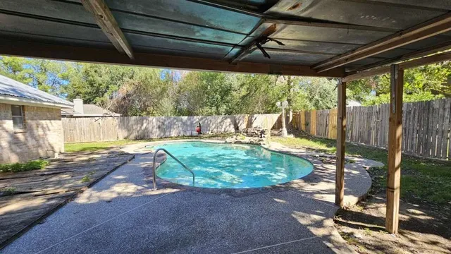 a backyard of a house with a fountain table and chairs
