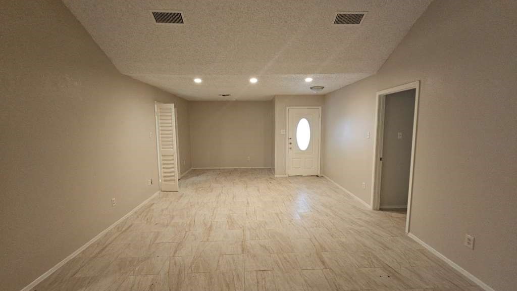 5410 Dibello Forest Lane Spring, TX 77373 - Photo 2 of 13 an empty room with wooden floor and windows