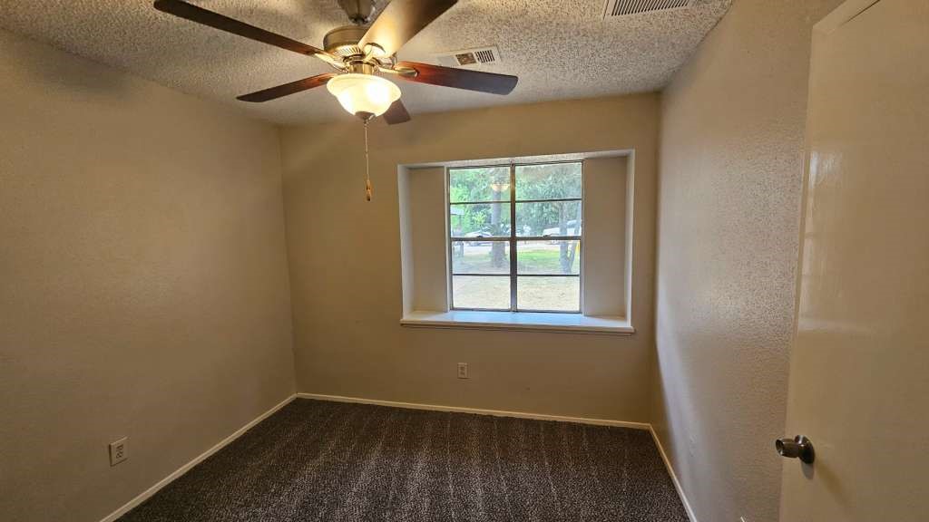 5410 Dibello Forest Lane Spring, TX 77373 - Photo 9 of 11 an empty room with a window and a fan