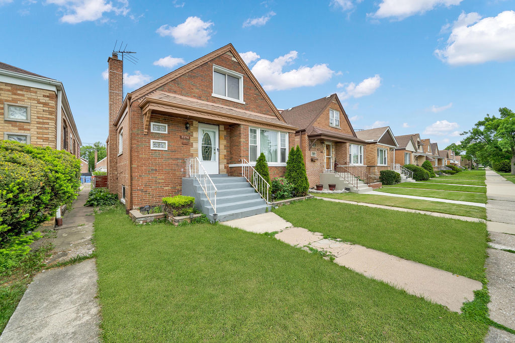 7234 South Ridgeway Avenue Chicago, IL 60629 - Photo 27 of 27 a front view of a house with a yard