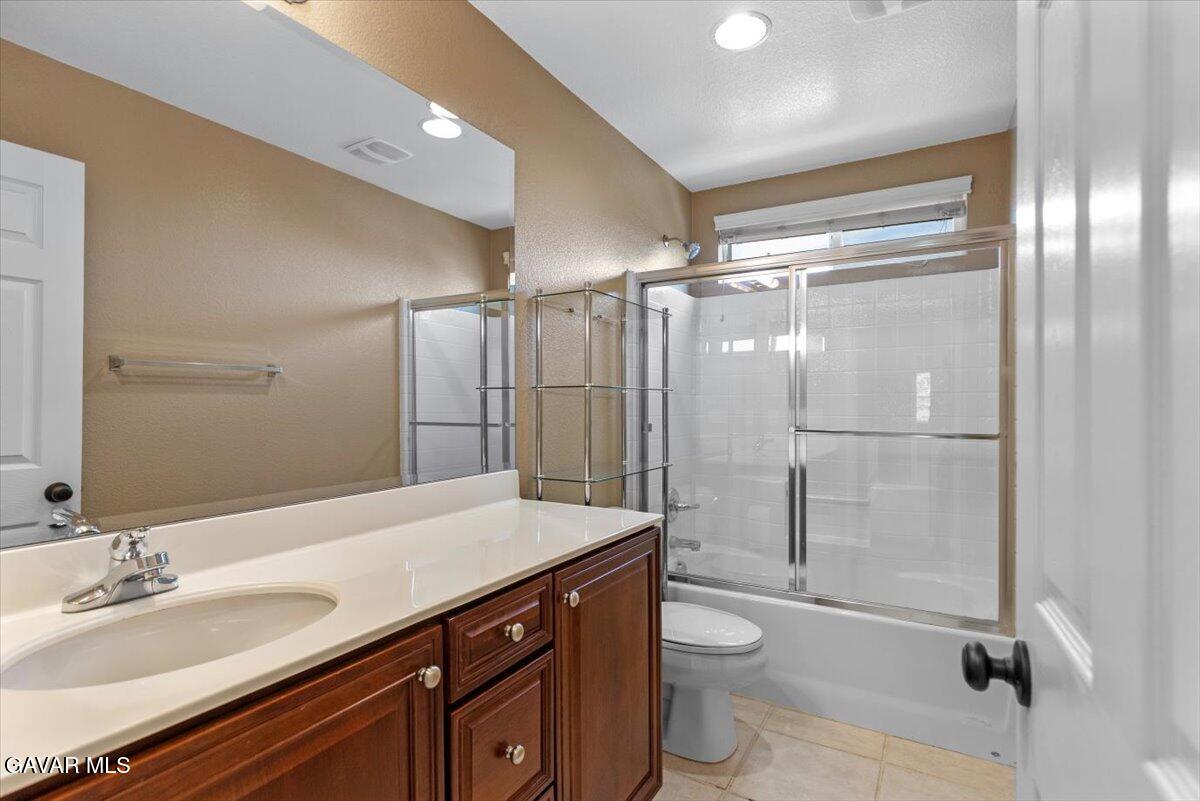 1450 Green Street Tehachapi, CA 93561 - Photo 15 of 27 a bathroom with a granite countertop sink toilet and shower