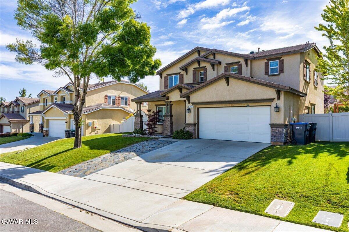 1450 Green Street Tehachapi, CA 93561 - Photo 2 of 27 a front view of a house with a yard and garage
