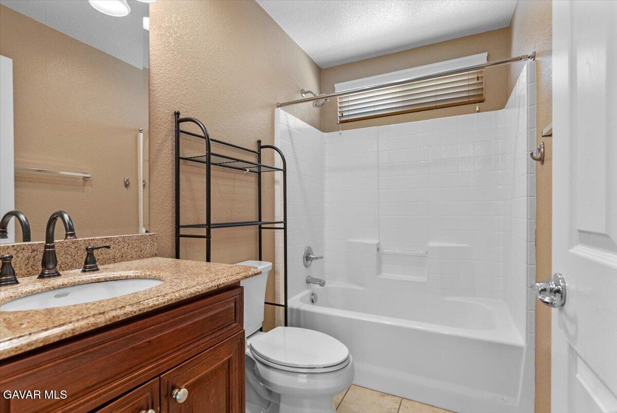 1450 Green Street Tehachapi, CA 93561 - Photo 5 of 27 a bathroom with a granite countertop sink toilet and shower