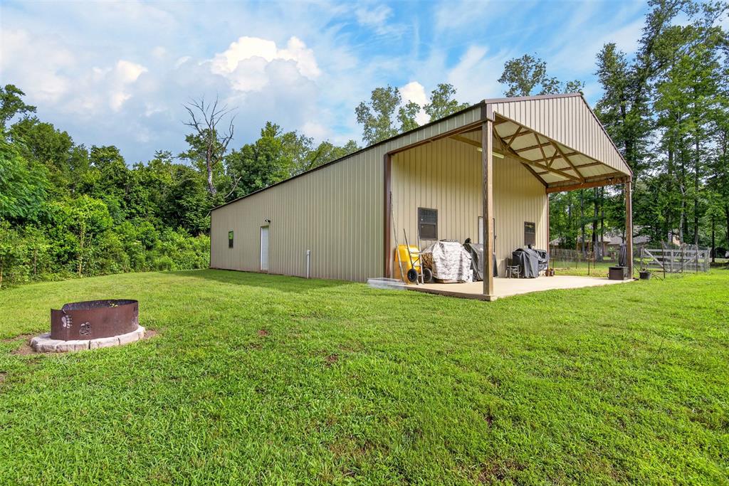 11868 Timber Ridge Drive Keithville, LA 71047 - Photo 35 of 37 Metal-sided auxiliary building with a covered concrete patio