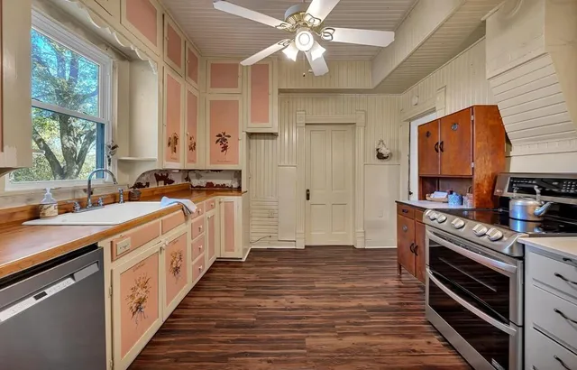 a kitchen with granite countertop a stove and a refrigerator