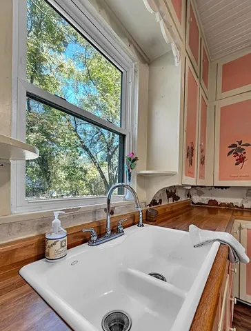 a large kitchen with stainless steel appliances a lot of counter space and a window