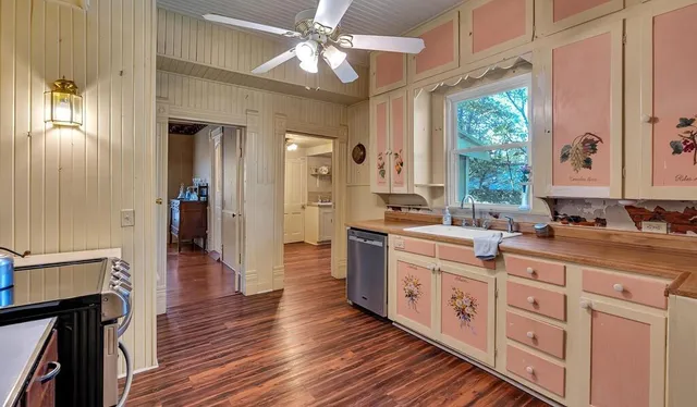 a view of a kitchen with cabinets and wooden floor