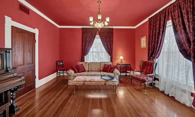 a living room with furniture and a chandelier