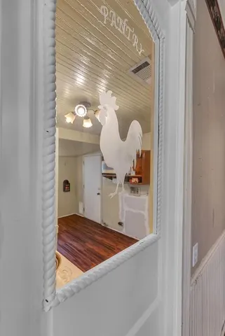 a kitchen with stainless steel appliances a stove top oven a sink dishwasher and a refrigerator with wooden floor