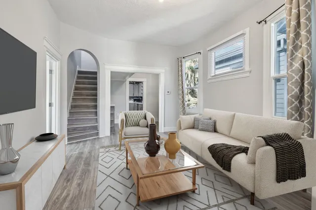 a living room with furniture and wooden floor