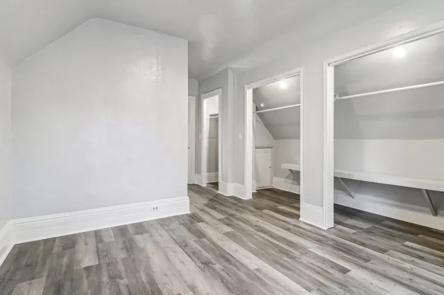 a view of a room with wooden floor