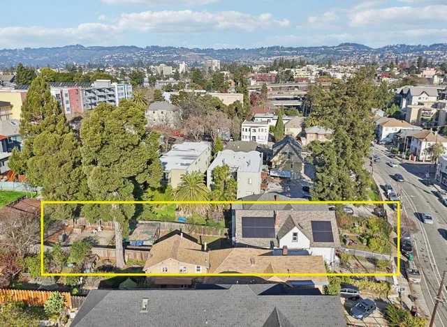 an aerial view of residential houses with city view