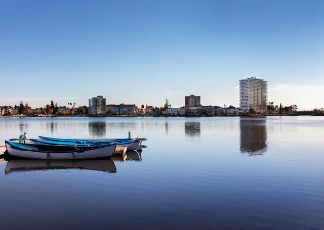 a view of multi story residential apartment building with a yard and potted plants