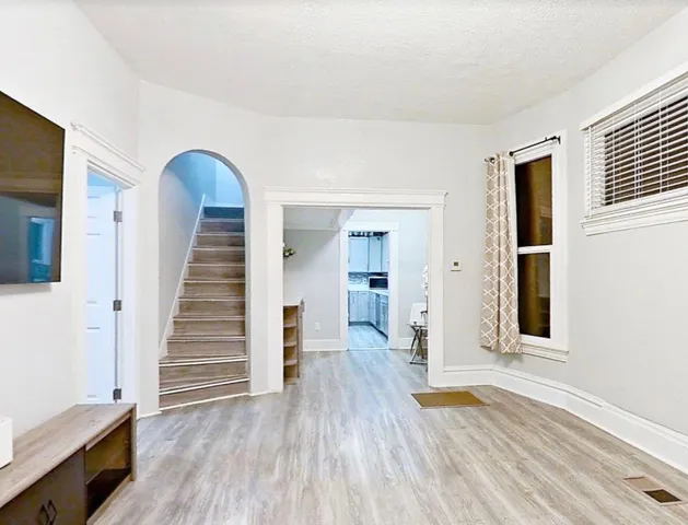 a view of a room with wooden floor and stairs