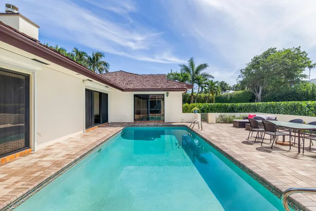 a view of a backyard with sitting area