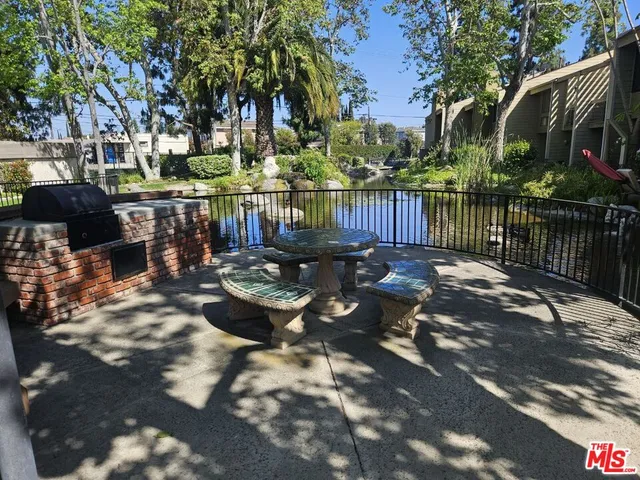 a view of a patio with iron fence