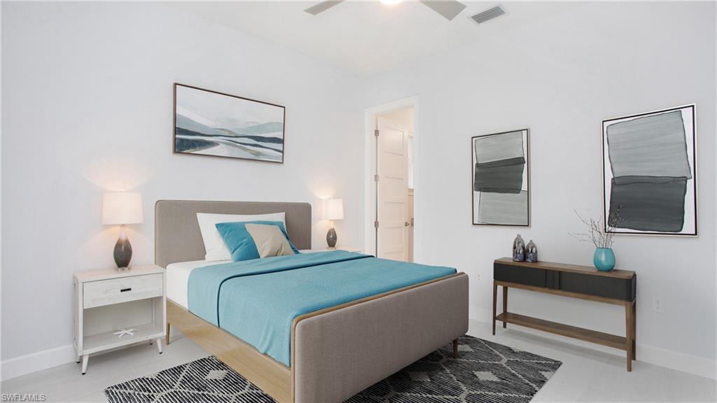 5060 Martinique Drive Naples, FL 34113 - Photo 16 of 38 a bedroom with a bed and a flat screen tv