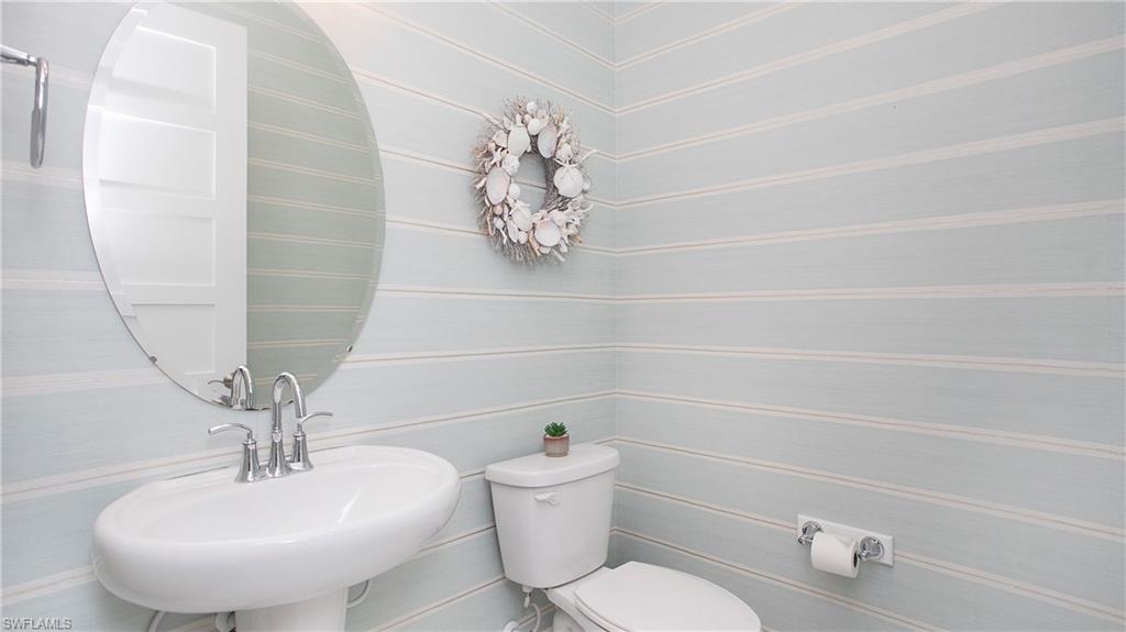 5060 Martinique Drive Naples, FL 34113 - Photo 21 of 38 a bathroom with a sink a toilet and a mirror