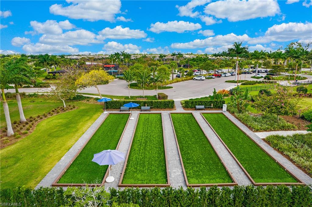 5060 Martinique Drive Naples, FL 34113 - Photo 36 of 38 a view of yard with swimming pool and outdoor seating