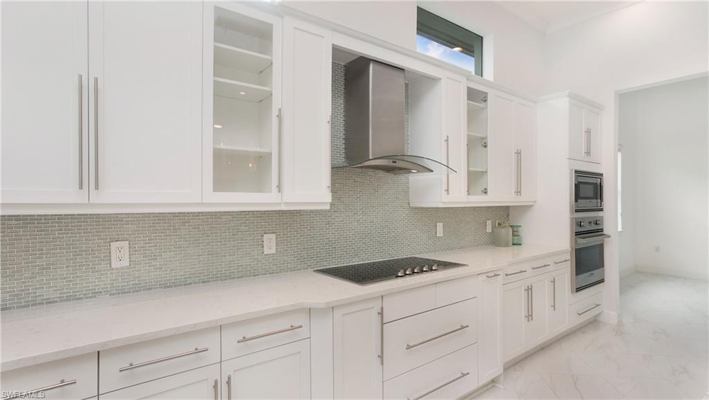 5060 Martinique Drive Naples, FL 34113 - Photo 7 of 38 a kitchen with cabinets appliances and a sink