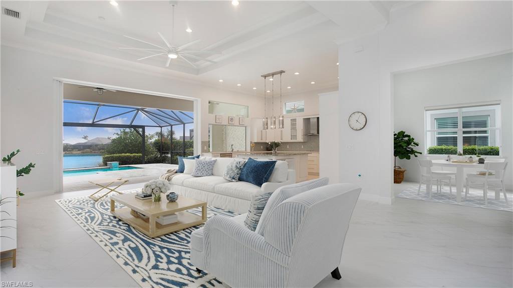 5060 Martinique Drive Naples, FL 34113 - Photo 8 of 38 a living room with furniture fireplace and a large window