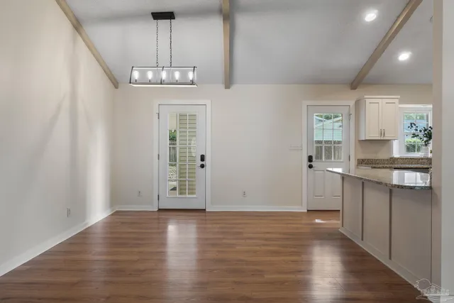 a view of kitchen with granite countertop cabinets and wooden floor