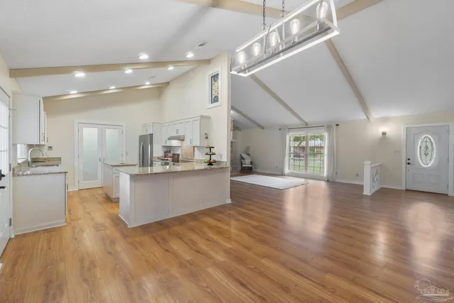 a view of kitchen and hall with wooden floor