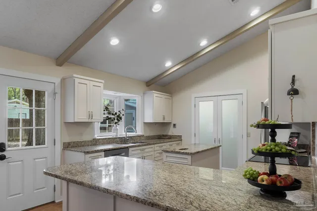 a kitchen with stainless steel appliances granite countertop sink stove and cabinets