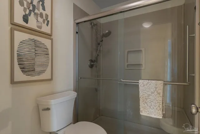a bathroom with a toilet and a shower